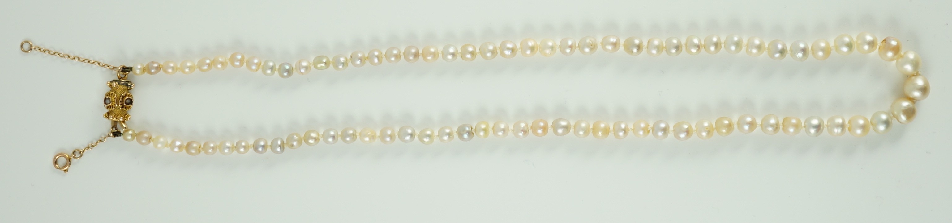 A single strand graduated natural saltwater pearl necklace